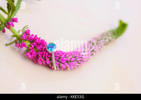 Round topaz engagement ring on natural romantic background Stock Photo