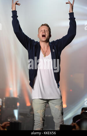 MIAMI BEACH, FL - DECEMBER 30: Macklemore performs during Orange Bowl Beach Bash on December 30, 2015 in Miami Beach, Florida.  People:  Macklemore Stock Photo