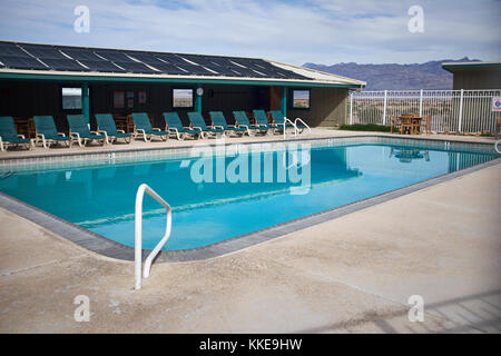 Cool blue swimming pool at a resort or hotel in Death Valley National Park on a cloudy overcast day Stock Photo