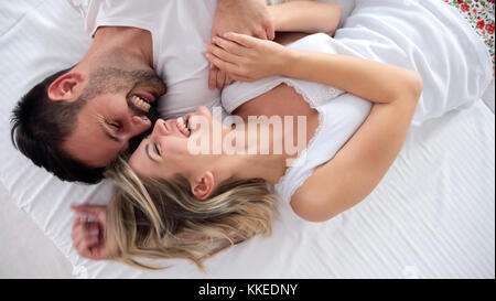 Happy couple having romantic times in bedroom Stock Photo