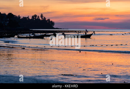 Long tail boats at sunset on Kamala Beach, Phuket Island, Thailand Stock Photo