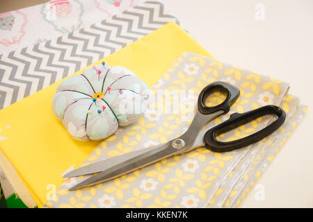 Pins and needles in a pin sponge, tailor accessories, scissors Stock Photo