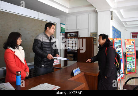 (171205) -- LIUZHOU, Dec. 5, 2017 (Xinhua) -- Li Fusong (1st R), 79, a retired teacher, talks with staff members of local education authorities about the Peking Opera training for students in Liuzhou City, south China's Guangxi Zhuang Autonomous Region, Nov. 21, 2017. Li has been fond of the Peking Opera since childhood, but she didn't get the chance to learn the opera until her retirement in 1994. During her self-study in the following ten years, she found that most of the opera fans were just middle-aged and old people. She then made a resolution to pass on the traditional art to young peopl Stock Photo