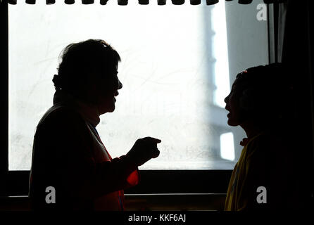 (171205) -- LIUZHOU, Dec. 5, 2017 (Xinhua) -- Li Fusong, 79, a retired teacher, directs a child to perform the Peking Opera at the children's center in Liuzhou City, south China's Guangxi Zhuang Autonomous Region, Dec. 3, 2017. Li has been fond of the Peking Opera since childhood, but she didn't get the chance to learn the opera until her retirement in 1994. During her self-study in the following ten years, she found that most of the opera fans were just middle-aged and old people. She then made a resolution to pass on the traditional art to young people with her own efforts. Li opened the Pek Stock Photo