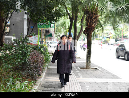 (171205) -- LIUZHOU, Dec. 5, 2017 (Xinhua) -- Li Fusong, 79, a retired teacher, walks to her Peking Opera training class in Liuzhou City, south China's Guangxi Zhuang Autonomous Region, Nov. 21, 2017. Li has been fond of the Peking Opera since childhood, but she didn't get the chance to learn the opera until her retirement in 1994. During her self-study in the following ten years, she found that most of the opera fans were just middle-aged and old people. She then made a resolution to pass on the traditional art to young people with her own efforts. Li opened the Peking Opera class for free at Stock Photo