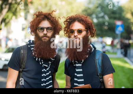 Milan, Italy - September 22, 2017: Famous twins, Fabrizio and Valerio Salvadori posing during Armani's fashion show and wearing sunglasses. Stock Photo