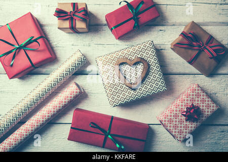 packed gifts and wrapping paper on white wood table. top view Stock Photo