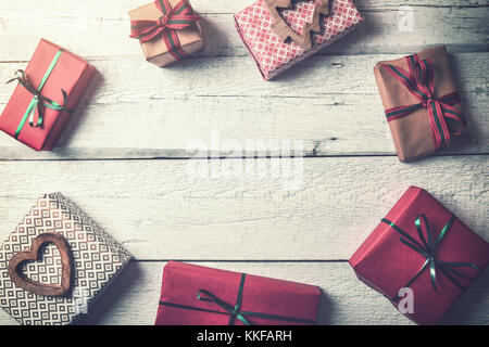wrapped christmas gifts on wooden background with copy space. flat lay Stock Photo