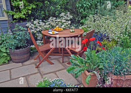 A quiet corner of an urban garden with seating area for eating Stock Photo