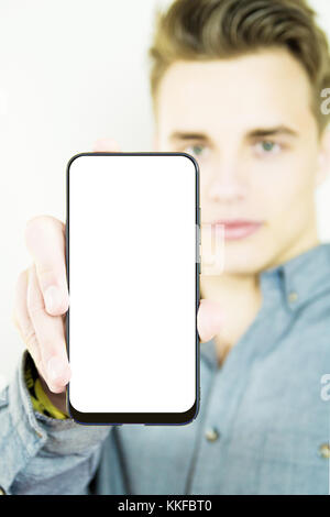 Handsome millennial showing generic blank full screen smartphone Stock Photo