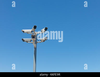 Image with various video surveillance cameras. Six cctv security cameras on the street pylon. Security cameras mounting on the high top position Stock Photo