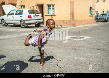 Little girl playing on the street, Langa, Cape Town, South Africa Stock Photo