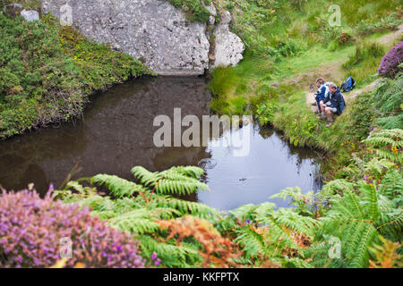 Couple resting by pond on Lundy Island, Devon, England UK in August Stock Photo