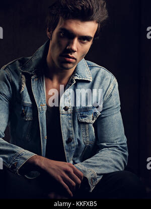 Stylish male fashion model wearing jeans and denim jacket with hands in  pockets looking at camera. Full body length isolated on white background  Stock Photo - Alamy