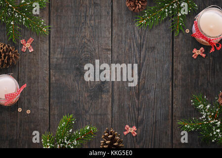 Simple Christmas background with candles in the jar and fir branches. Free space for text in the middle. Stock Photo