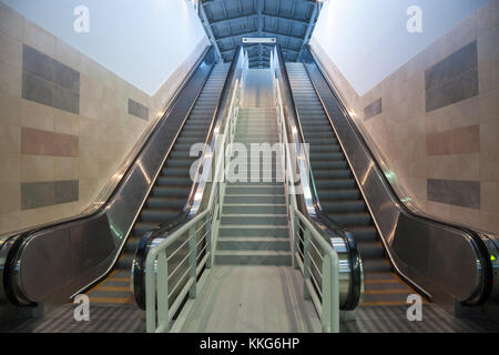 Escalators in movement in a train station, going from the underground to the platform  Picture of mecanical stairs, or escalators, in movementm withou Stock Photo