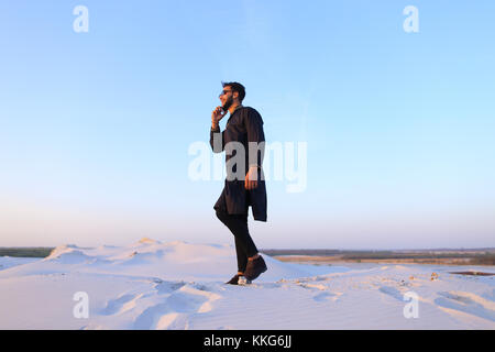 Handsome male Arab businessman talks on cellular business pro, s Stock Photo