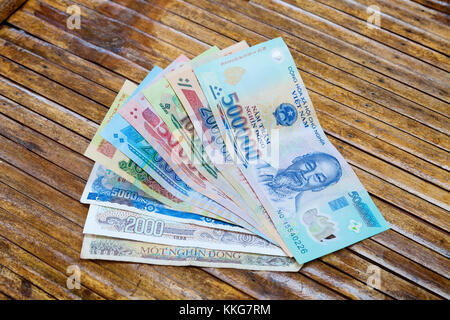 Vietnam Dong banknotes on wooden table Stock Photo