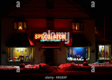 Night view of famous Speculator Department Store in Speculator, NY, with Christmas decorations and window treatments. Stock Photo