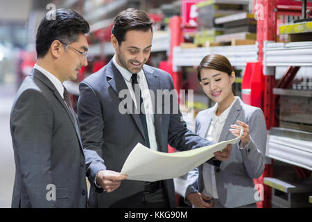 Businessman and engineer talking in the factory Stock Photo