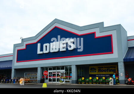 Lowe's home improvement center warehouse store with lawn tractors, plants and wheelbarrows lined up in front. Stock Photo