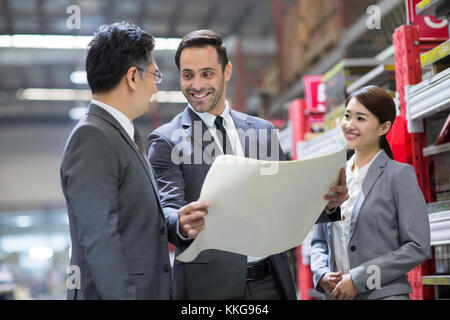 Businessman and engineer talking in the factory Stock Photo