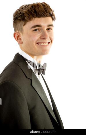 18 year old wearing a tuxedo smiling isolated on a white background Stock Photo