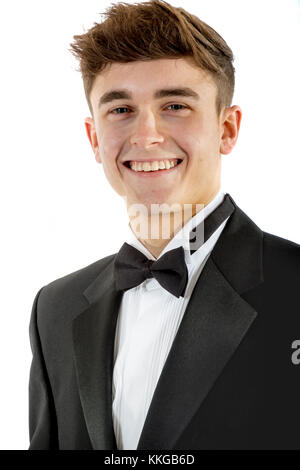 18 year old wearing a tuxedo smiling isolated on a white background Stock Photo