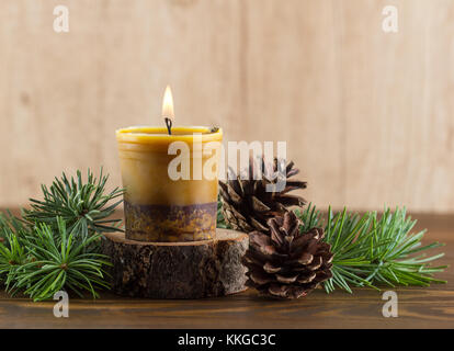 Burning handmade beewax candle with cinnamon.Advent wreath Stock Photo