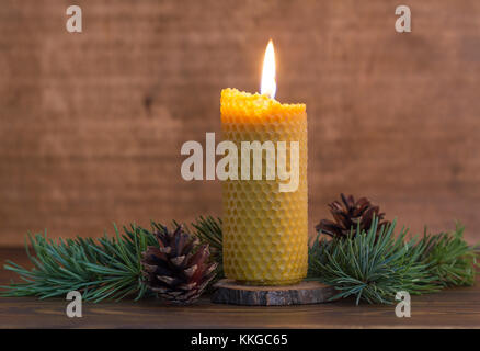 Burning handmade beewax candle. Advent wreath Stock Photo