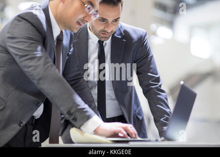 Businessmen working with laptop in the factory Stock Photo