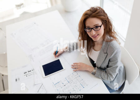 Young beautiful architect working on project in office Stock Photo
