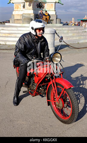 senior man riding old red moto guzzi motorcycle, florence, italy Stock Photo