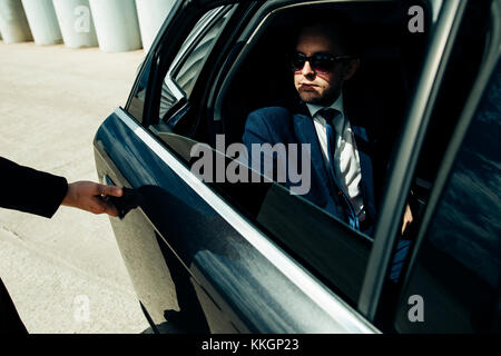 Cropped image of businessman opening door on his car Stock Photo