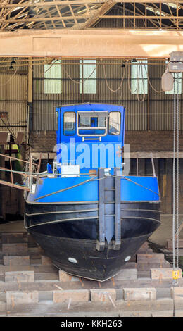 Canal and River Trust working barge in dry dock under repair Newark - On - Trent Nottinghamshire England UK Stock Photo