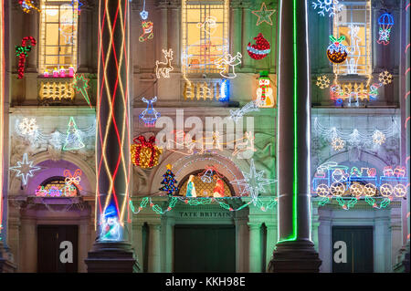 London, UK.  1 December 2017.  Alan Kane's new festive work, 'Home for Christmas', is unveiled at Tate Britain.  'Home for Christmas' transforms the exterior of the gallery into a glowing display of off-the shelf decorations with an arrangement of LED Santas, reindeer, snowmen and Christmas trees, along with ‘Merry Christmas’ and ‘Santa Stop Here’ signs.  The artwork will be switched on daily from 2 December 2017 to 6 January 2018.  Credit: Stephen Chung / Alamy Live News Stock Photo