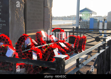 Portland, Dorset. 1st Dec 2017 - Remembrance Day wreaths catch the sunlight on Weymouth beach, on the first official day of Winter Credit: stuart fretwell/Alamy Live News Stock Photo