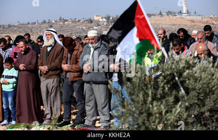 Nablus, West Bank, Palestinian Territory. 2nd Dec, 2017. Palestinians perform Friday prayer at the site that where a Palestinian Mahmoud Odeh, 48, was shot dead by an Israeli settler yesterday, in the northern village of Qusra in the occupied West Bank near Nablus on December 1, 2017 Credit: Shadi Jarar'Ah/APA Images/ZUMA Wire/Alamy Live News Stock Photo