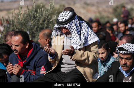 Nablus, West Bank, Palestinian Territory. 2nd Dec, 2017. Palestinians perform Friday prayer at the site that where a Palestinian Mahmoud Odeh, 48, was shot dead by an Israeli settler yesterday, in the northern village of Qusra in the occupied West Bank near Nablus on December 1, 2017 Credit: Shadi Jarar'Ah/APA Images/ZUMA Wire/Alamy Live News Stock Photo