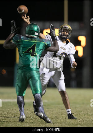 Delray Beach, Florida, USA. 1st Dec, 2017. Miami Stingarees quarterback Isaias Castellon (12) is pressured by Atlantic Eagles outside linebacker Darius Mosley (4) in the second quarter in Delray Beach, Florida on December 1, 2017. Credit: Allen Eyestone/The Palm Beach Post/ZUMA Wire/Alamy Live News Stock Photo