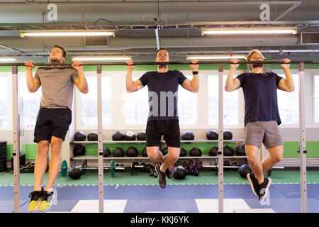 group of young men doing pull-ups in gym Stock Photo - Alamy