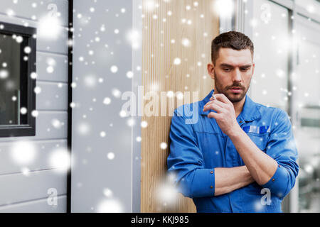 auto mechanic smoking cigarette at car workshop Stock Photo