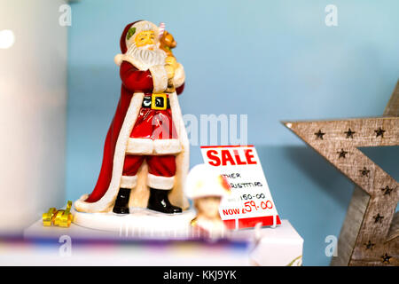 Ceramic or Bone China Santa Claus figure on sale in a display in a shop window in a mall in the UK Stock Photo