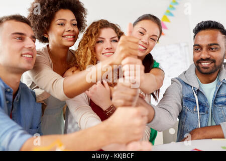 happy office workers doing teamwork gesture Stock Photo