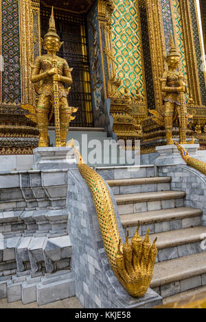 Bangkok, Thailand.  Demons (Yakshas)  and Five-headed Naga (Snake) Guarding Entrance to the Phra Mondop, Royal Grand Palace Compound.