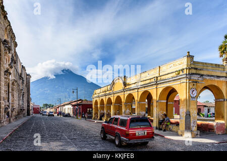 Antigua, Guatemala - October 22, 2017: Santa Clara ruins, Tanque de la Union public laundry tank & Agua volcano in colonial city Stock Photo