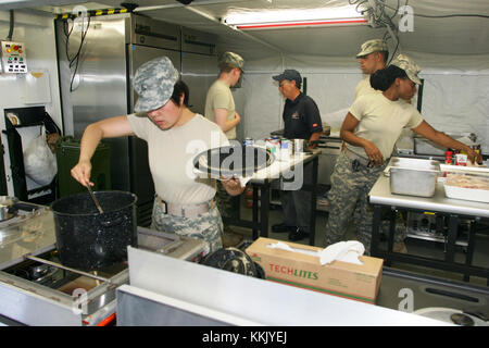 Students in the 80-hour sustainment course for Soldiers in the 68M (nutritional-care specialist) military occupational specialty prepare a meal in a containerized kitchen at the Fort McCoy Regional Training Site-Medical complex June 10, 2015. The 68M Soldiers perform basic dietetic functions in a hospital, clinic, or field environment. Students in the course were with the 801st Combat Support Hospital at Fort Sheridan, Ill. (U.S. Army Photo by Scott T. Sturkol, Public Affairs Office, Fort McCoy, Wis.) Stock Photo