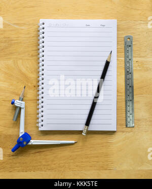 Notebook With Black Pencil On Wooden Table Stock Photo