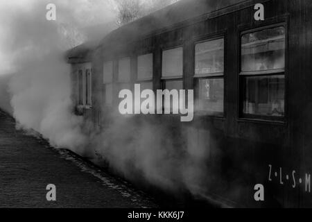 An old steam locomotive standing at the Simpelveld train station waiting for the passengers to enter the train. This picture was taken on a cold winte Stock Photo