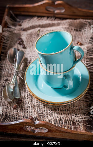 Rustic blue coffee cup on old burlap napkin Stock Photo